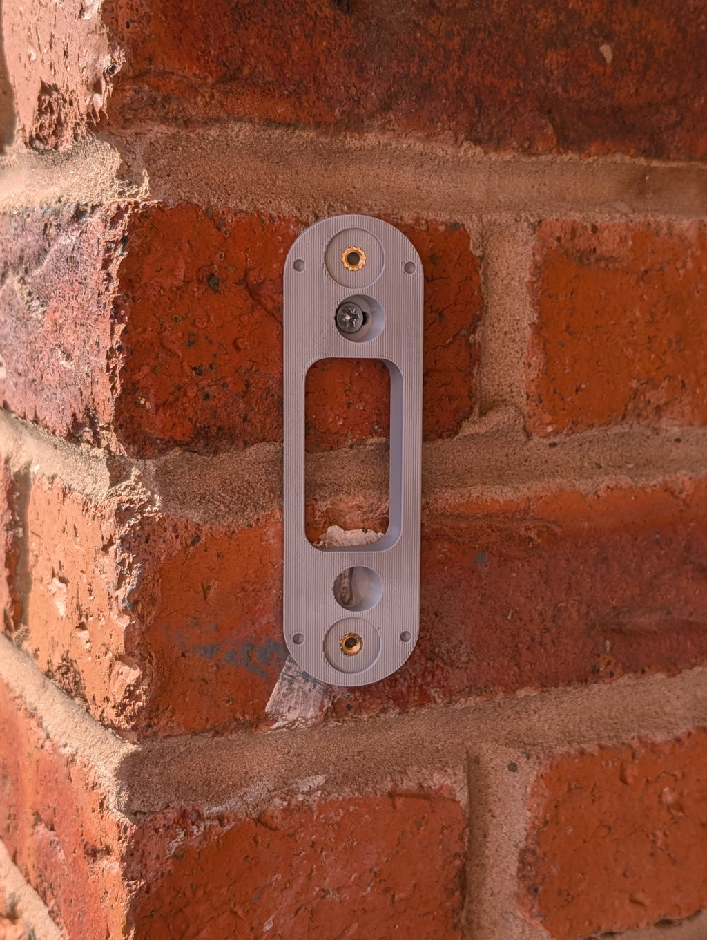 Angled wedge mount for Arlo Gen2 Doorbell, in grey.