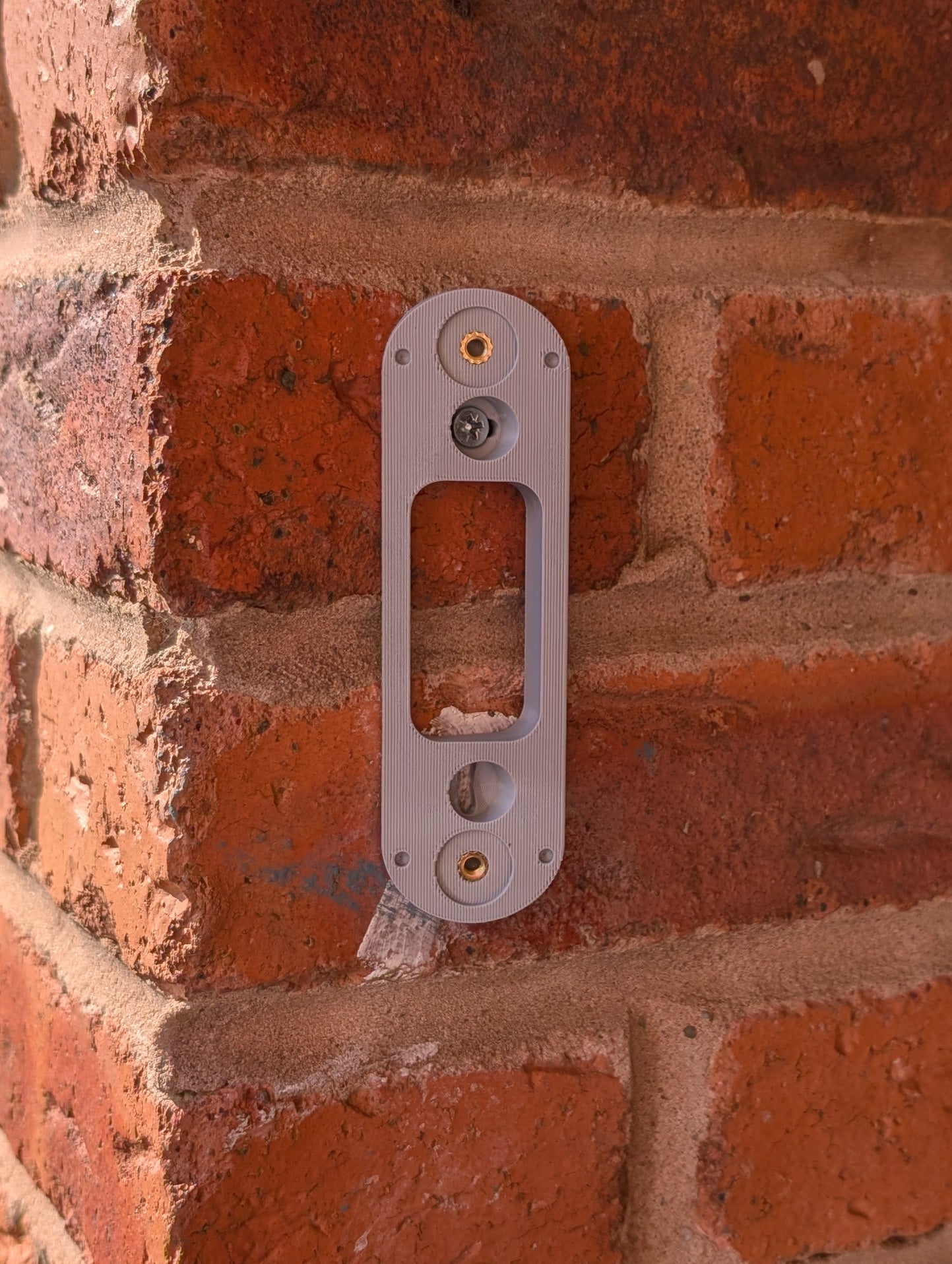 Angled wedge mount for Arlo Gen2 Doorbell, in grey.