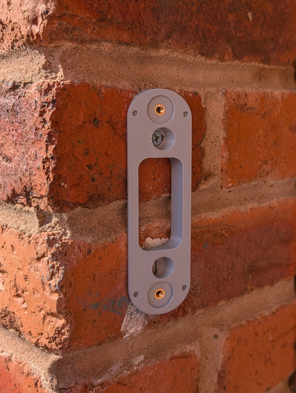 Angled wedge mount for Arlo Gen2 Doorbell, in grey.