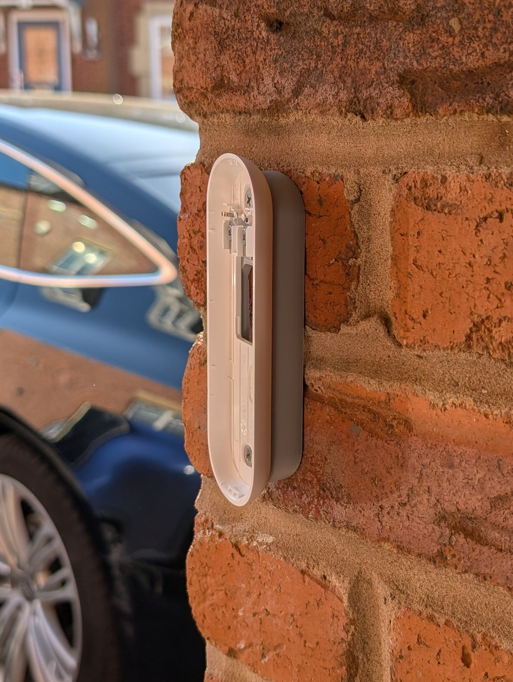 Angled wedge mount for Arlo Gen2 Doorbell, in grey.