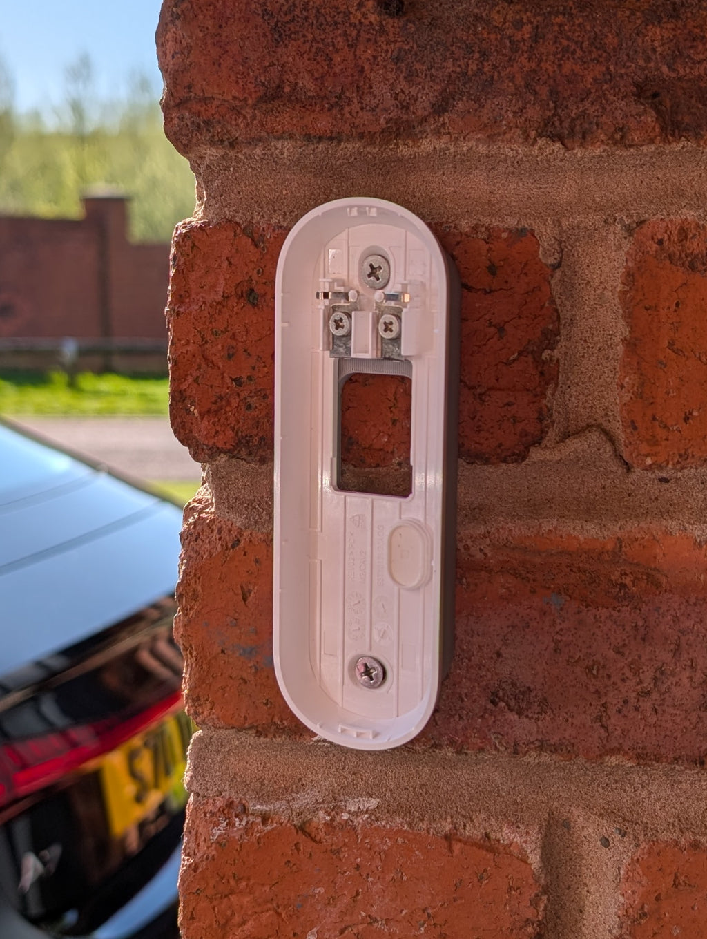 Angled wedge mount for Arlo Gen2 Doorbell, in grey.