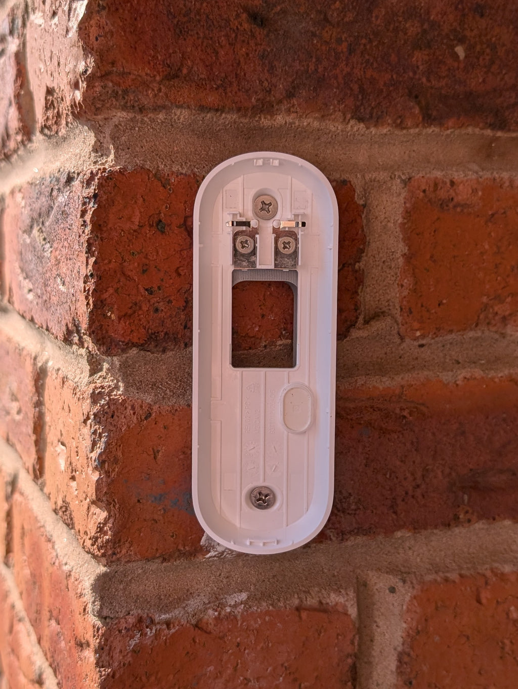 Angled wedge mount for Arlo Gen2 Doorbell, in grey.