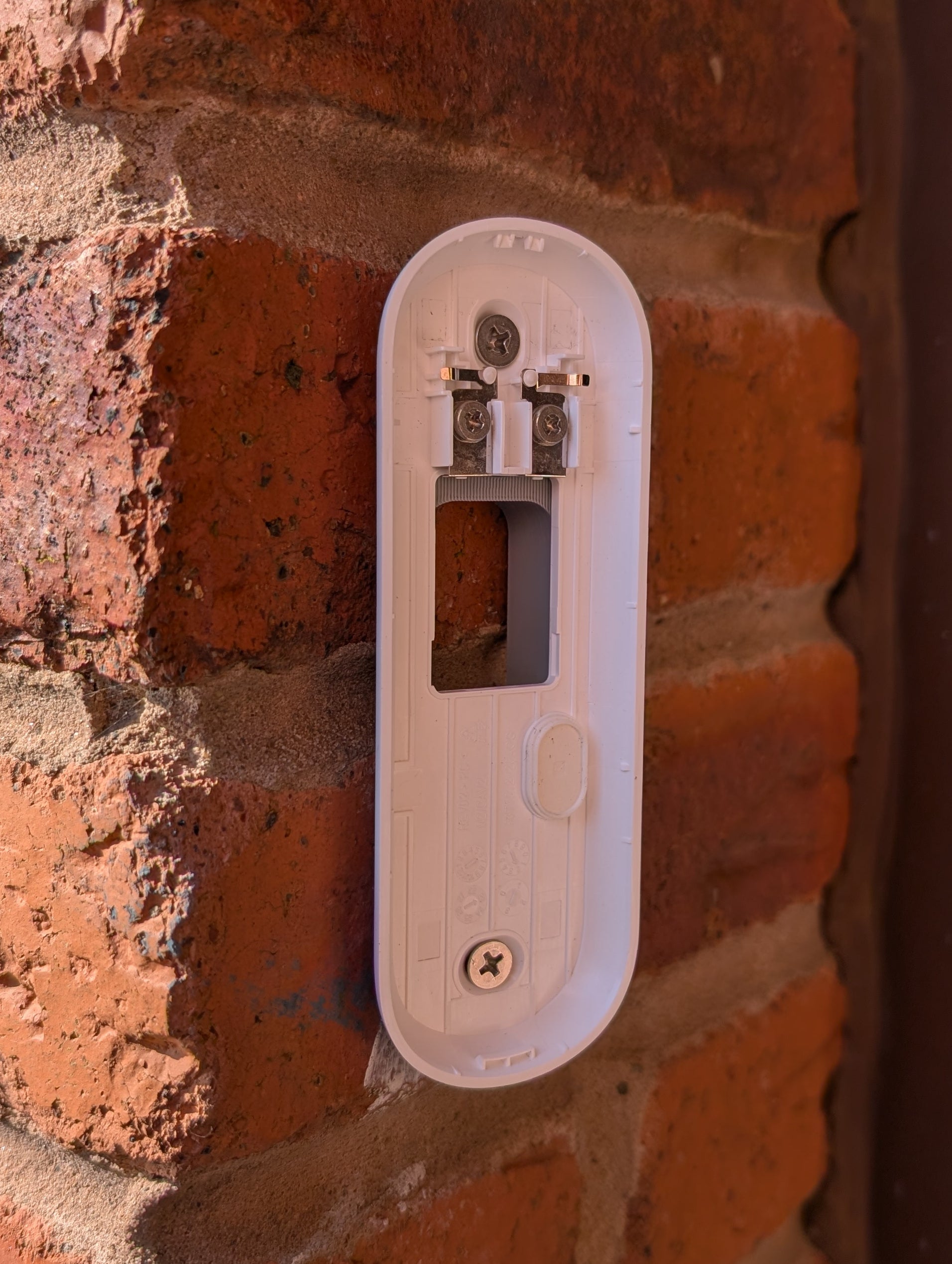 Angled wedge mount for Arlo Gen2 Doorbell, in grey.