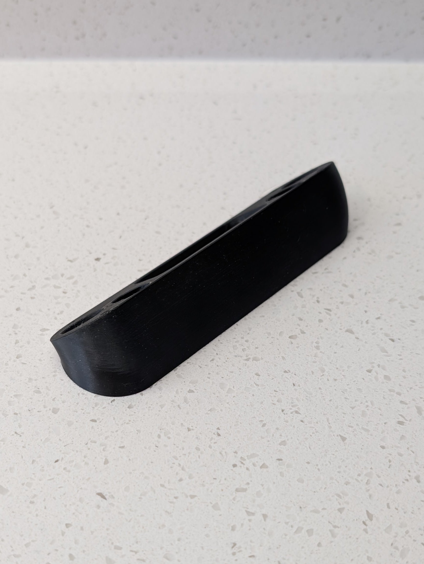 Angled wedge mount for Arlo Gen2 Doorbell, in black.